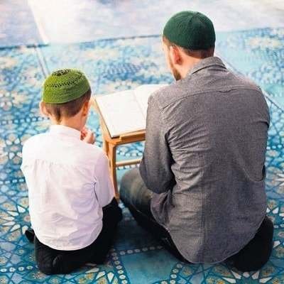 teacher is teaching word to word Quran to child